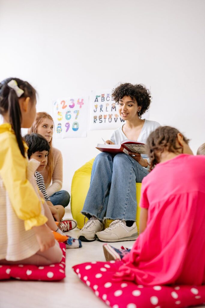 woman reading a book to children